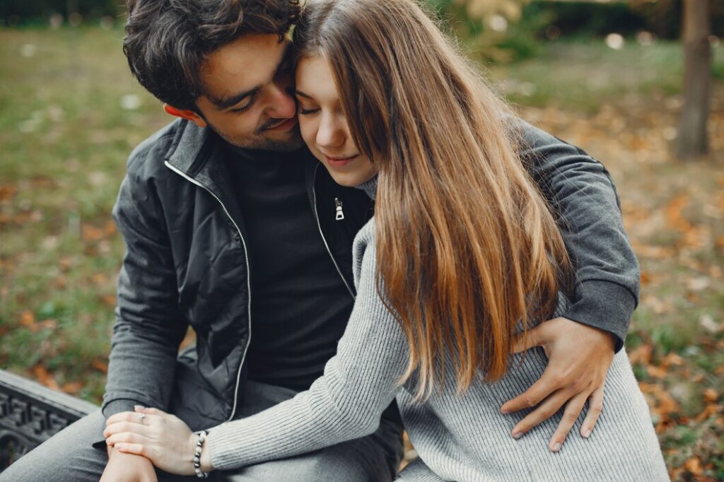 Wome hugging man at bench