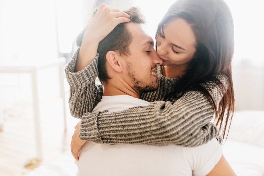 Women kissing man on his nose 