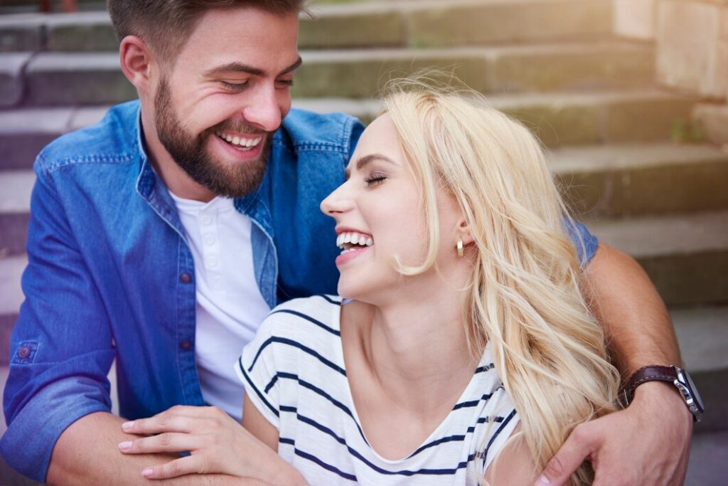 Couple sitting together and laughing